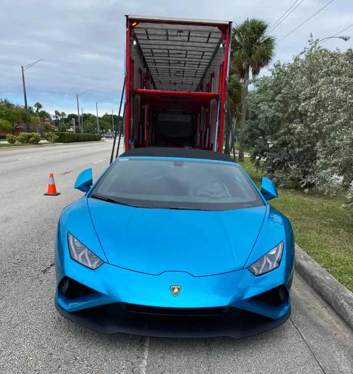 Enclosed vehicle transport trailer keeping cars safe from road debris